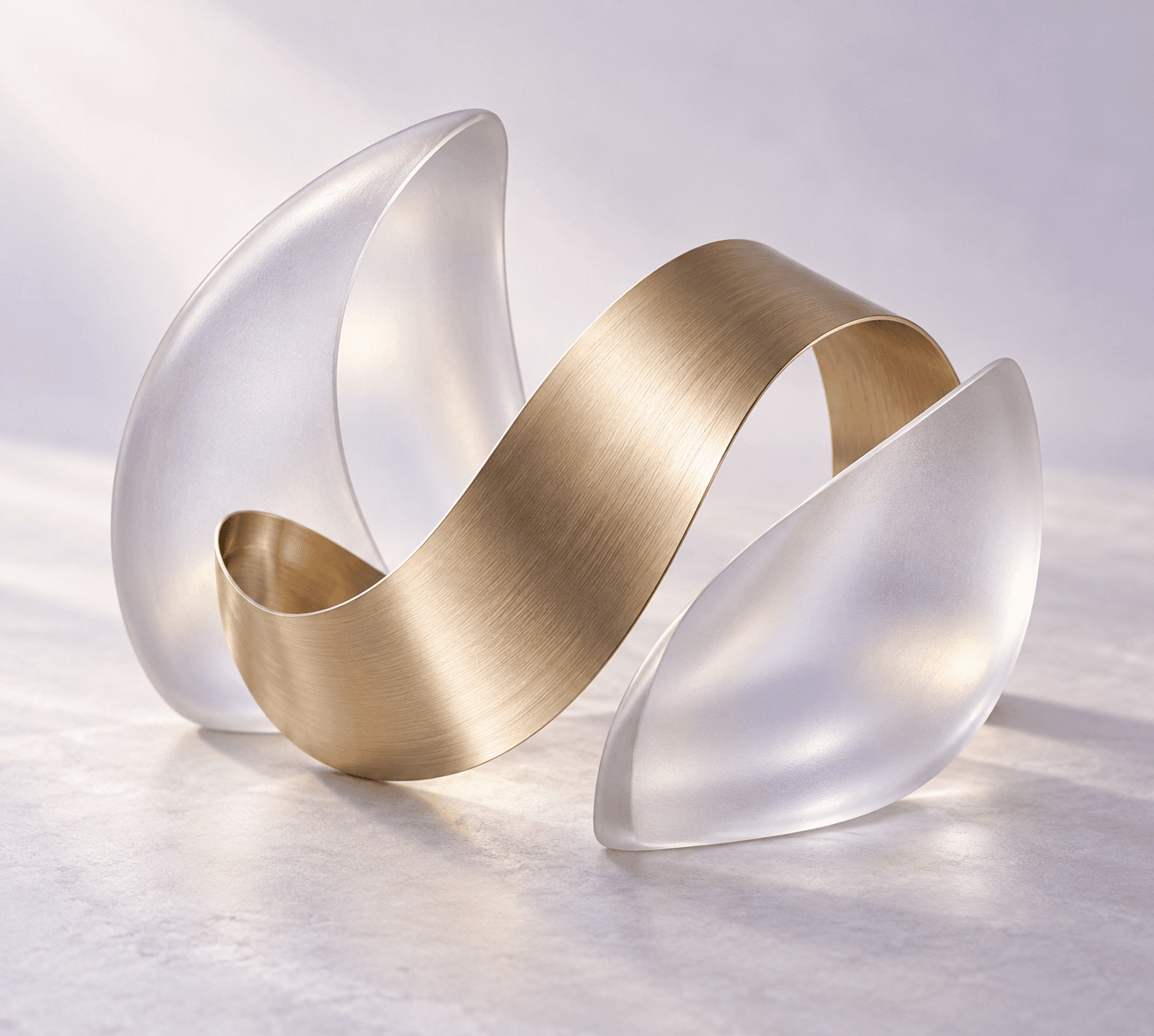 Sculptural frosted glass with a brushed gold ribbon